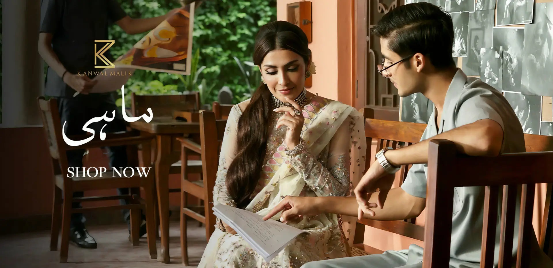 Two people sitting at a table, Pakistani Model Ayeza Khan in Kanwal Malik Designer Dress with Pakistani Model Feroz Khan.