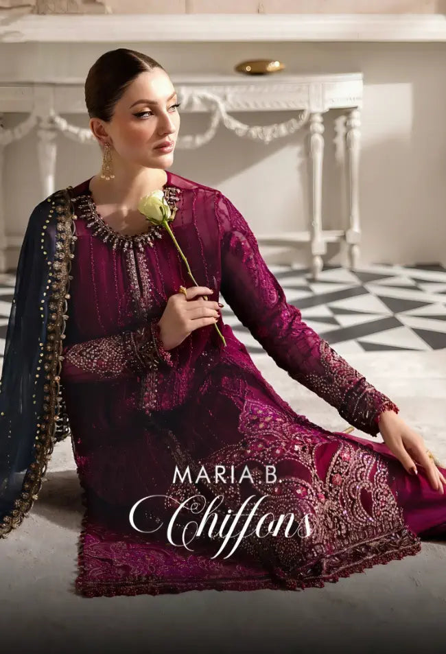 Woman in a purple embroidered outfit holding a rose, with 'Maria B Chiffons' branding.